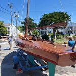 wooden boat on a trailer in the street named best classic sail