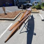 wooden kayak on a trailer in a parking space named best paddle boat
