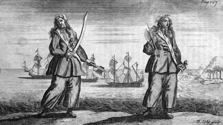 illustration of female pirates anne bonny and mary read standing near one another and holding weapons with ships in the background